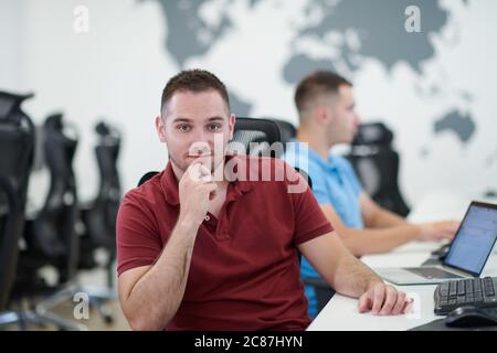 startup business, two male software developers working on computer at new modern open plan office Stock Photo