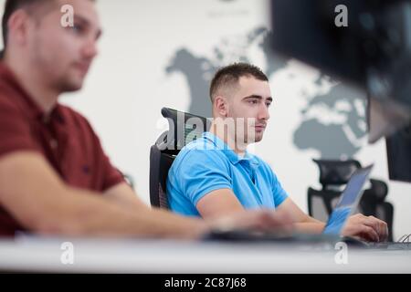 startup business, two male software developers working on computer at new modern open plan office Stock Photo
