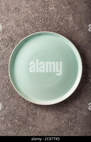 Ceramic empty plate on grey concrete background. Stock Photo