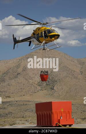 Near Goodsprings Nv, United States. 21st July, 2020. Helicopters filling up water buckets just off State Route 160 NV to fight the Cottonwood fire in a remote area on July 21, 2020 near Goodsprings, Nevada. Credit: Peter Noble/The Photo Access Credit: The Photo Access/Alamy Live News Stock Photo