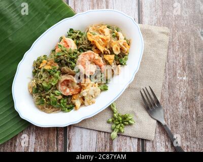 Stir fry glass noodle with shrimp and cowslip creeper ( Dok Kajon pad Woonsen) - Thai authentic food Stock Photo