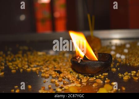close up image of burning diya in temple as a religious symbol Stock Photo