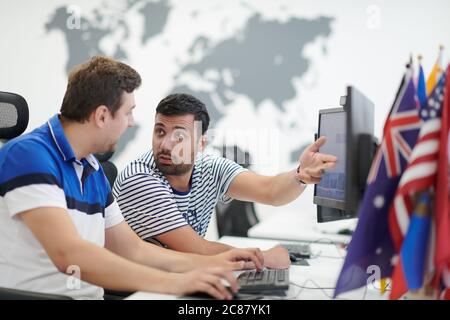 startup business, two male software developers working on computer at new modern open plan office Stock Photo