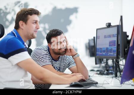 startup business, two male software developers working on computer at new modern open plan office Stock Photo