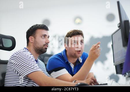 startup business, two male software developers working on computer at new modern open plan office Stock Photo