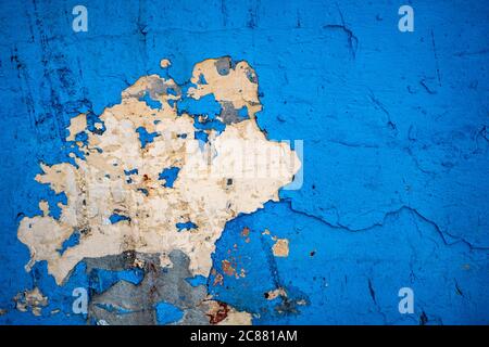 old wall with dry and cracked blue paint on abandoned house, background Stock Photo