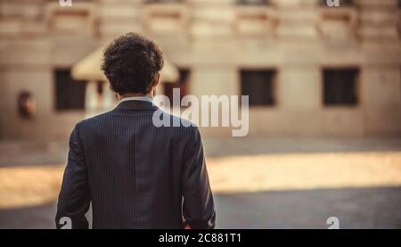 male portrait standing alone in the city. back view Stock Photo