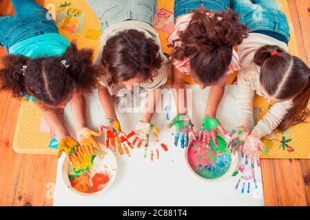 Children painting with their hands during the art class Stock Photo