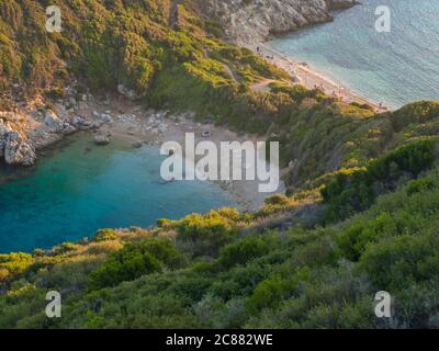 Corfu, Greece, Porto Timoni. View of the most famous double beach and bay in Afionas from the view point on the path. Sunset golden golden hour light Stock Photo