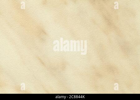 Texture of light beige marble with brown lines of a pattern, macro background. Pastel sand color stone backdrop from mineral tile, closeup. Stock Photo