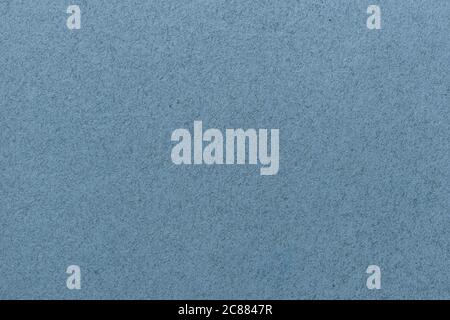 Texture of old light blue paper closeup. Structure of a matte dense cardboard wallpaper. Denim felt background. Stock Photo