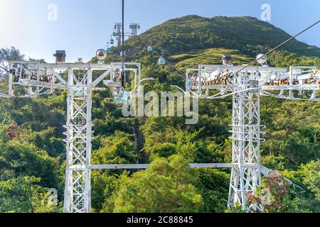 The sunny view of cable car and theme park near to ocean Stock Photo