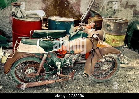 Junk Motorcycles Abandoned. Old retro style motorbikes diss used with oil drums and other junk in landfill. Stock Image Stock Photo Alamy