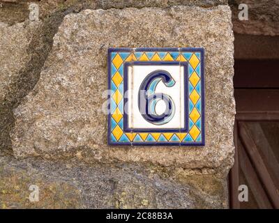 Door sign number 6 tile plate on the wall in the Azulejo style Stock Photo