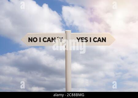 Yes I can concept. Wooden sign post with text isolated on sky background Stock Photo