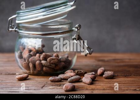 Cacao beans in a glass container Stock Photo