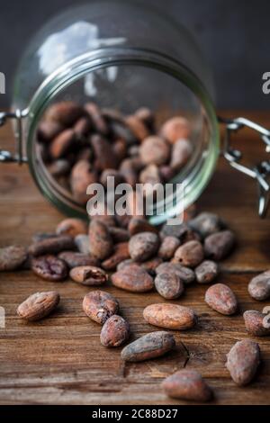 Cacao beans in a glass container Stock Photo
