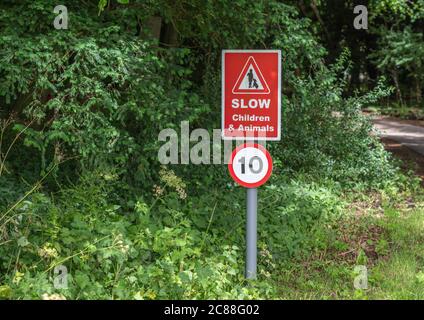 Slow children and animals red road sign with a 10 speed limit Stock Photo