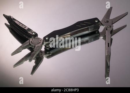 grey swiss knife isolated on white background Stock Photo