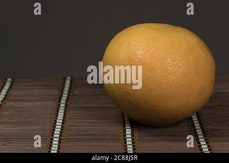 One grapefruit on a bamboo background Stock Photo