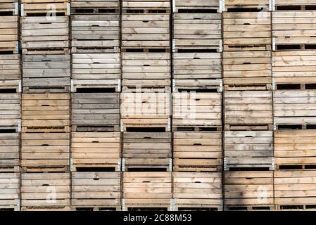 Wooden fruit boxes stacked on top of each other. Fruit containers prepared before harvest. Stock Photo