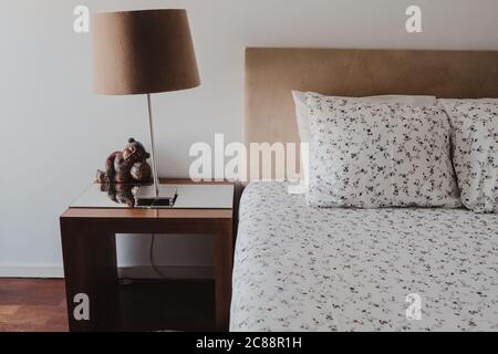 Selective focus shot a modern bedroom and a lampshade with a white wall background Stock Photo