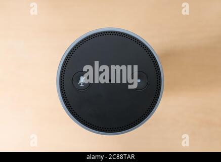 Top down view of a well-known, voice activated personal speaker. Showing the cylinder design and button controls. Stock Photo