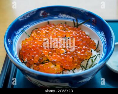 Hakodate, Hokkaido, Japan - Ikura don, a Japanese traditional rice bowl dish topped with red caviar made from the roe of salmon. Kaisen don. Stock Photo