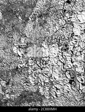 Fragment of silver graffiti painted on a wall. Bright abstract backdrop for design with peeling paint. Stock Photo