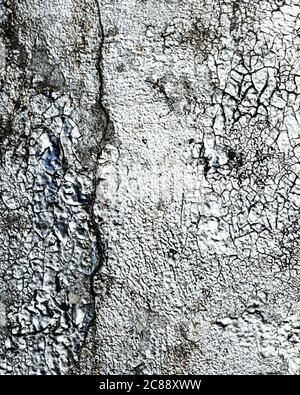 Fragment of silver graffiti painted on a wall. Bright abstract backdrop for design with peeling paint. Stock Photo