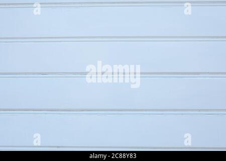 Wooden texture of a white wall sheathed with planks. Painted wood plank surface, low contrast, background image for design use. Stock Photo
