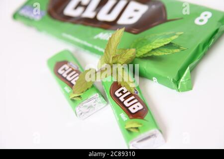 McVities Club Chocolate Bars, Mint flavour Club biscuit, on white with spring of mint herb Stock Photo