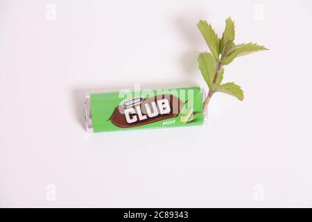 A McVities Club Chocolate biscuit bar, Mint flavour Club biscuit with spring of Mint herb, on white Stock Photo