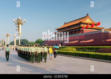 BEIJING, CHINA - JUNE 24, 2014: Soldiers March past tourists in front of The Tiananmen Gate. Stock Photo