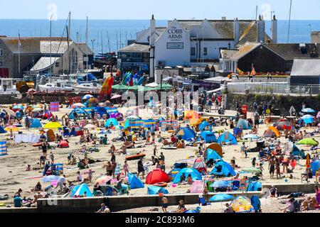 Lyme Regis, Dorset, UK.  22nd July 2020.  UK Weather. Sunbathers and holidaymakers flock to the beach at the seaside resort of Lyme Regis in Dorset on another day of scorching hot sunshine.  Picture Credit: Graham Hunt/Alamy Live News Stock Photo