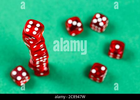 stack of red dice on green felt texture Stock Photo