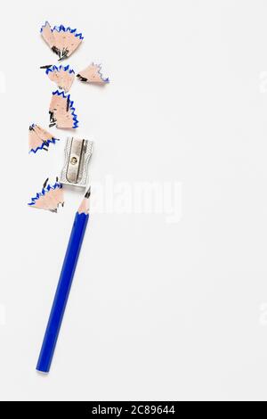 pencil and sharpener on blank paper surface Stock Photo