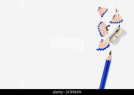 pencil and sharpener on blank paper surface Stock Photo