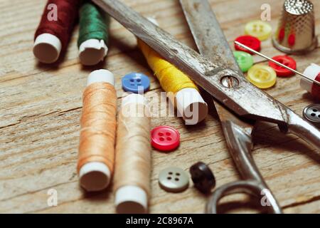 old scissors and sewing items on weathered wooden planks Stock Photo