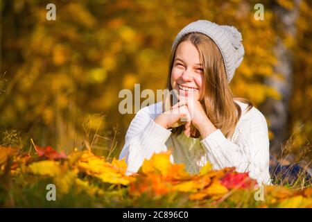 Portrait of pretty nice teenage girl with dental braces in autumn park , background with copy space for text, autumn special offer sale concept Stock Photo