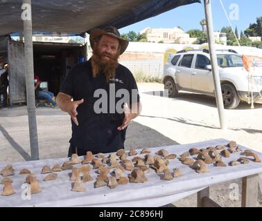 Jerusalem, Israel. 22nd July 2020. Archeologist Benjamin Storchan of the Israel Antiquities Authority shows ancient jar handles with seal impressions found during excavations of a significant administrative storage center from the days of Kings Hezekiah and Menashe (8th century to middle of the 7th century BCE) uncovered near the U.S. Embassy in Jerusalem, on Wednesday, July 22, 2020. Credit: UPI/Alamy Live News Stock Photo