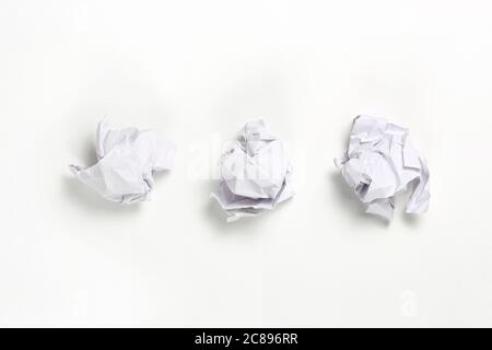 white crumpled paper balls on white surface Stock Photo