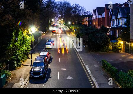 A night-time view of Stanhope Road from the bridge on Parkland Walk, cars and other traffic leaving light trails, London, UK Stock Photo