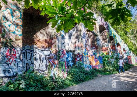 Railway arches on Parkland Walk, a disused railway, now a nature reserve, a popular site for graffiti artists, Crouch End, London, UK Stock Photo