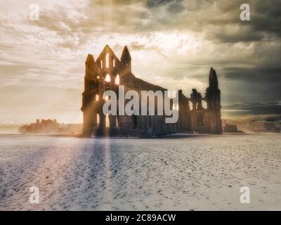 Whitby Abbey at sunset in snow, North Yorkshire, UK Stock Photo