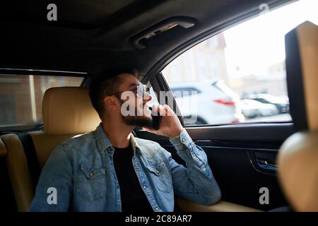 happy man is talking with his girlfriend in the car. close up side view photo Stock Photo