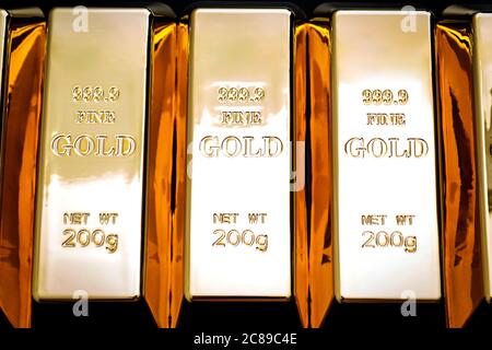 National reserve of gold, financial stability and commodity trading concept with many pure solid gold bars in a raw on black background Stock Photo