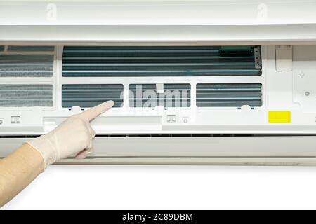 professional with gloves checking the filter of air conditioner Stock Photo