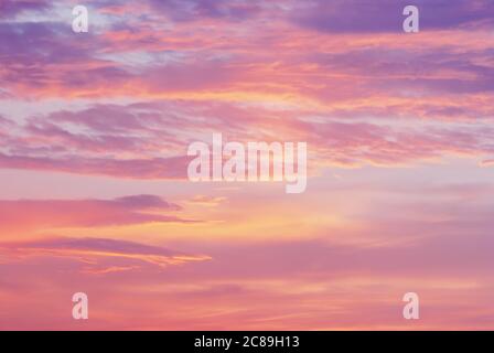pink purple orange clouds in sunset sky, blurry natural dawn sky background Stock Photo