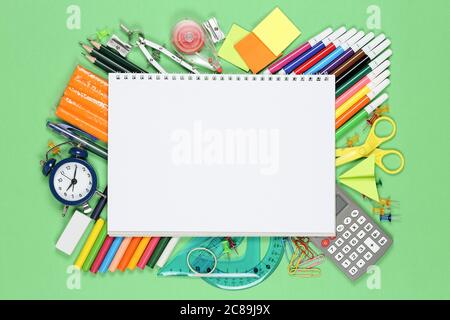 blank spiral notebook on large variety of school supplies Stock Photo